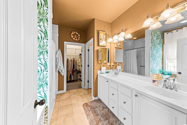 bathroom featuring walk in shower, tile patterned floors, and vanity