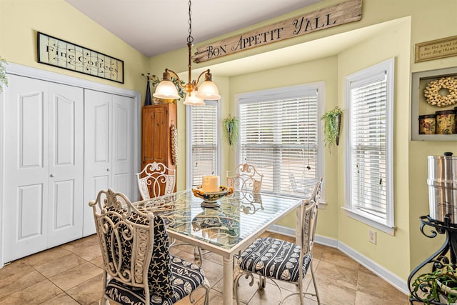 dining room with a notable chandelier and light tile patterned floors