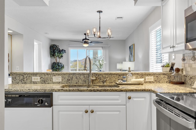 kitchen with sink, dishwasher, electric range, light stone countertops, and white cabinets