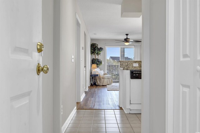 corridor featuring light tile patterned floors