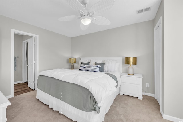 bedroom featuring light carpet and ceiling fan