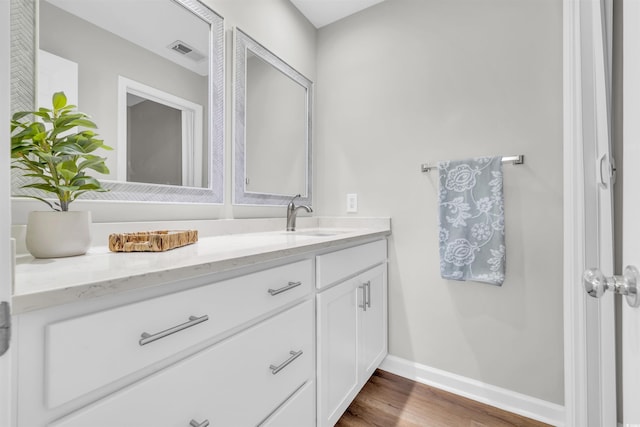 bathroom with hardwood / wood-style flooring and vanity