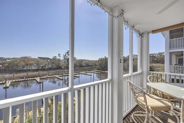 unfurnished sunroom featuring a water view