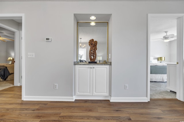 hallway with dark hardwood / wood-style flooring