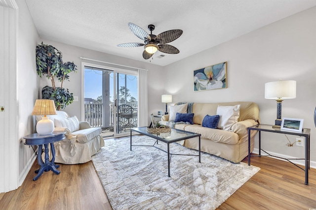 living room featuring light hardwood / wood-style floors and ceiling fan