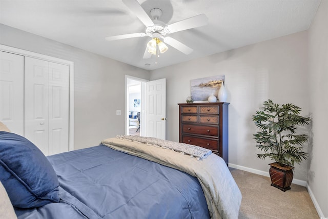 bedroom featuring ceiling fan, a closet, and light carpet