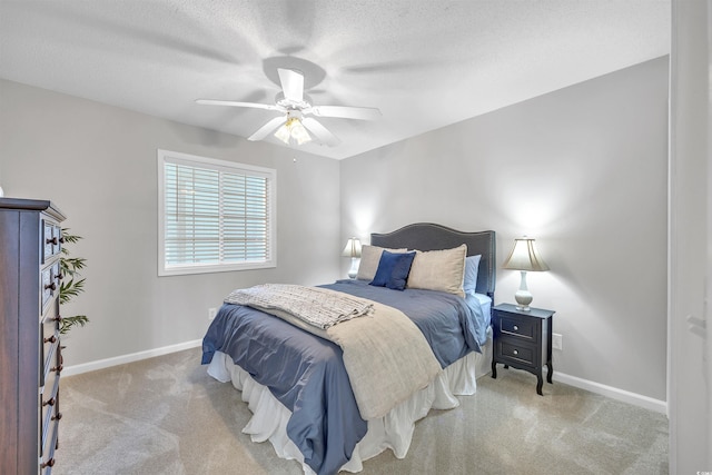 carpeted bedroom with ceiling fan and a textured ceiling