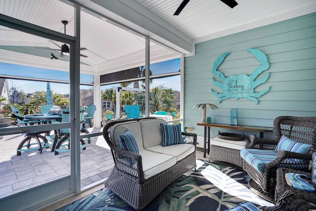 sunroom with a wealth of natural light and ceiling fan