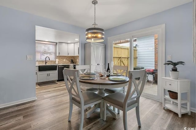 dining area featuring sink and light wood-type flooring