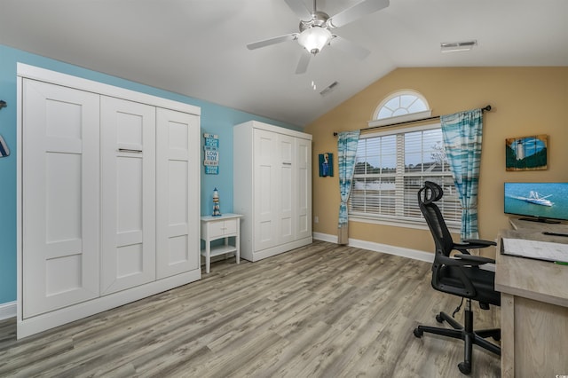 home office with vaulted ceiling, ceiling fan, and light wood-type flooring