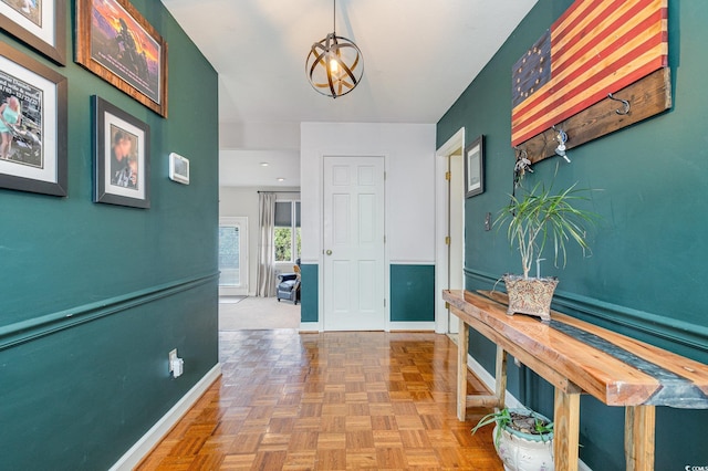 hall featuring parquet flooring