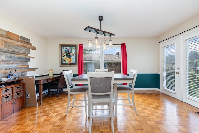 dining room featuring light parquet flooring and a wealth of natural light