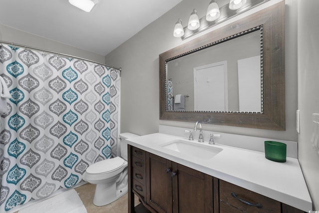 bathroom featuring vanity, tile patterned floors, and toilet