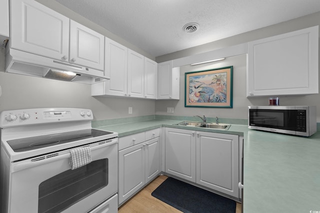 kitchen with sink, white cabinets, white electric range oven, a textured ceiling, and light hardwood / wood-style flooring