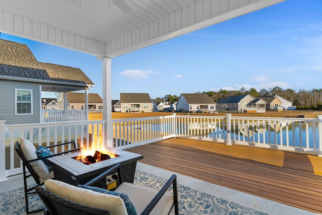 deck featuring a fire pit and a water view