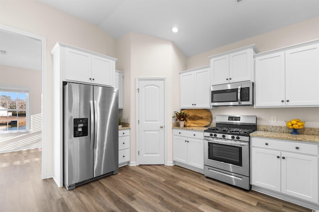 kitchen featuring appliances with stainless steel finishes, light stone countertops, and white cabinets