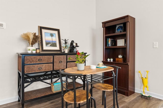 dining space with dark hardwood / wood-style floors