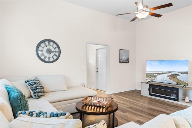 living room featuring hardwood / wood-style floors and ceiling fan