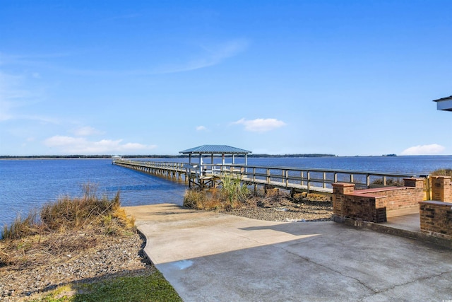 view of dock featuring a water view and a gazebo