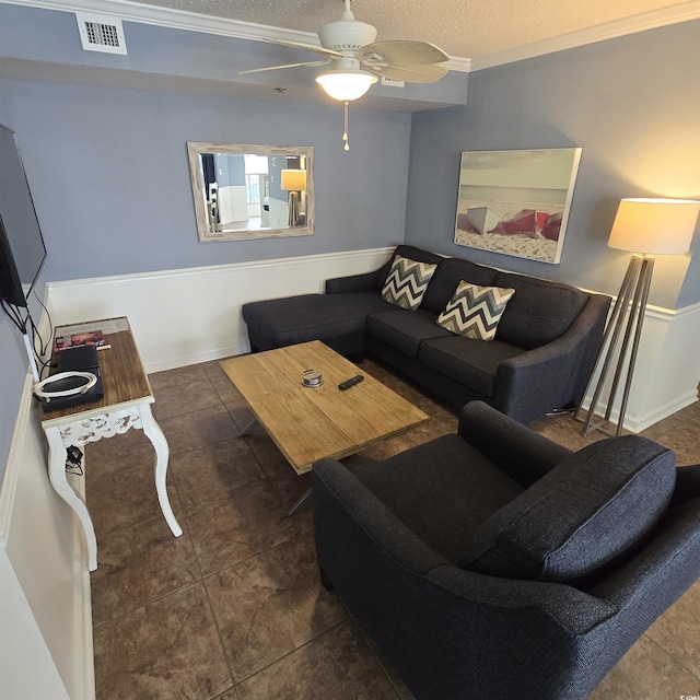 living room featuring ceiling fan and a textured ceiling