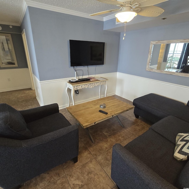 living room with crown molding, tile patterned floors, ceiling fan, and a textured ceiling