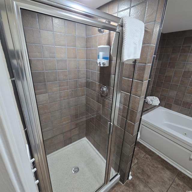 bathroom with tile patterned floors and shower with separate bathtub