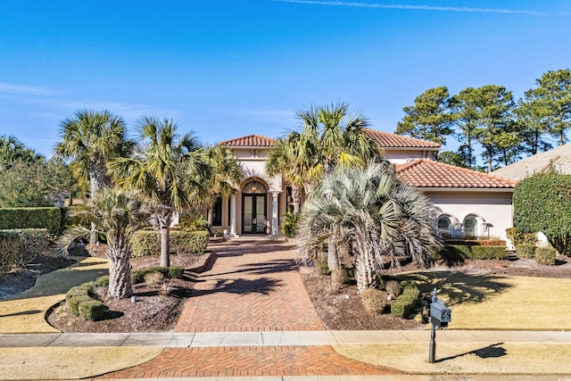 mediterranean / spanish-style house with french doors