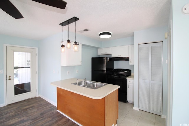 kitchen with sink, hanging light fixtures, black appliances, a textured ceiling, and white cabinets