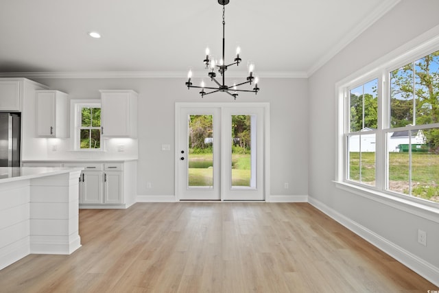 1201 Possum Trot Rd, North Myrtle Beach, SC 29582 - unfurnished dining area featuring a chandelier, plenty of natural light, light wood-style flooring, and ornamental molding