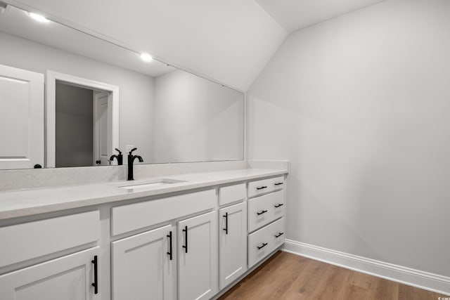 1201 Possum Trot Rd, North Myrtle Beach, SC 29582 - bathroom with wood finished floors, baseboards, vanity, and vaulted ceiling
