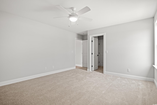 1201 Possum Trot Rd, North Myrtle Beach, SC 29582 - unfurnished bedroom with carpet floors, baseboards, a ceiling fan, and a walk in closet