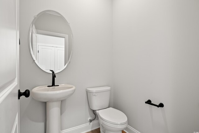 1201 Possum Trot Rd, North Myrtle Beach, SC 29582 - half bath with toilet, baseboards, and wood finished floors