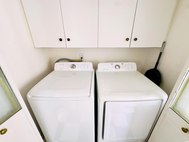 laundry room featuring cabinets and washer and dryer