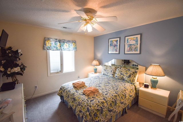 carpeted bedroom with a textured ceiling and ceiling fan