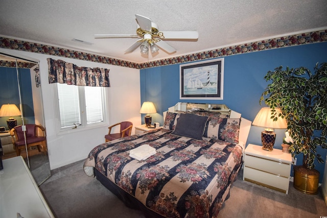 carpeted bedroom featuring a textured ceiling and ceiling fan