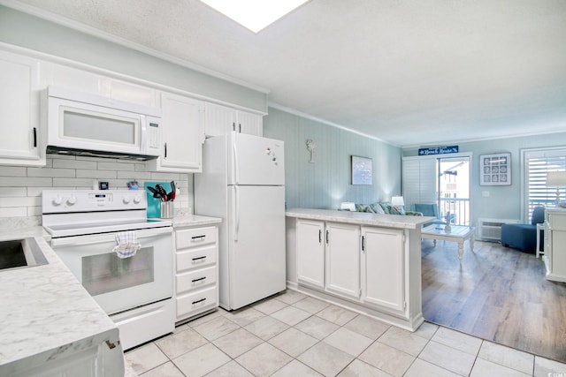 kitchen featuring white cabinetry, ornamental molding, white appliances, and kitchen peninsula