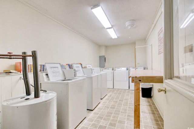 washroom with water heater and independent washer and dryer