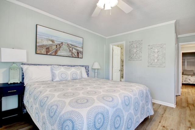 bedroom with ceiling fan, crown molding, light hardwood / wood-style floors, and a textured ceiling