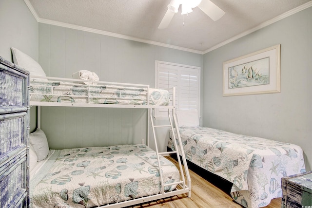 bedroom featuring crown molding, ceiling fan, hardwood / wood-style floors, and a textured ceiling