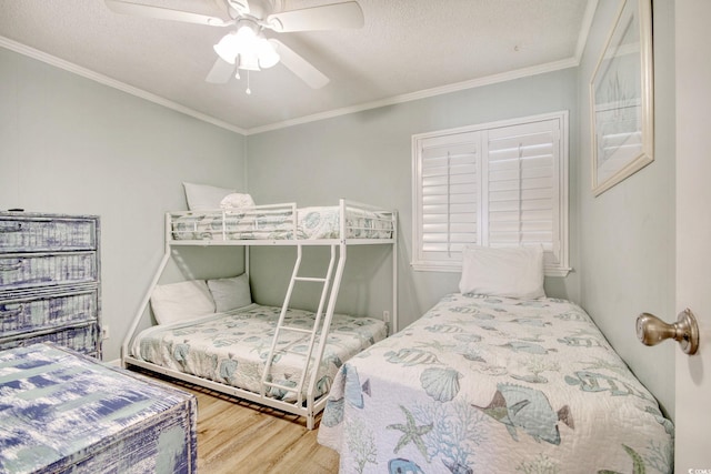 bedroom featuring crown molding, wood-type flooring, and a textured ceiling