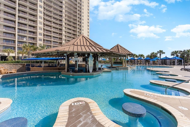 view of swimming pool featuring a gazebo and a jacuzzi