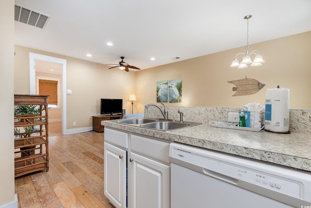 kitchen with sink, white dishwasher, light hardwood / wood-style floors, white cabinets, and decorative light fixtures