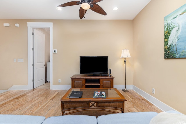 living room featuring hardwood / wood-style flooring and ceiling fan