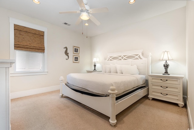 bedroom with ceiling fan and light carpet