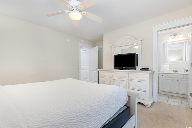 carpeted bedroom with ceiling fan and connected bathroom