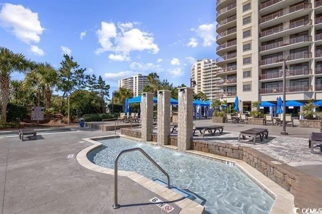 view of swimming pool featuring pool water feature