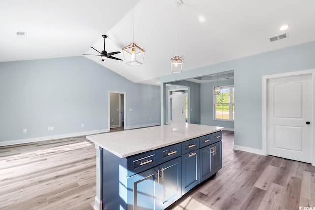 kitchen featuring blue cabinets, hanging light fixtures, a center island, ceiling fan, and light hardwood / wood-style floors