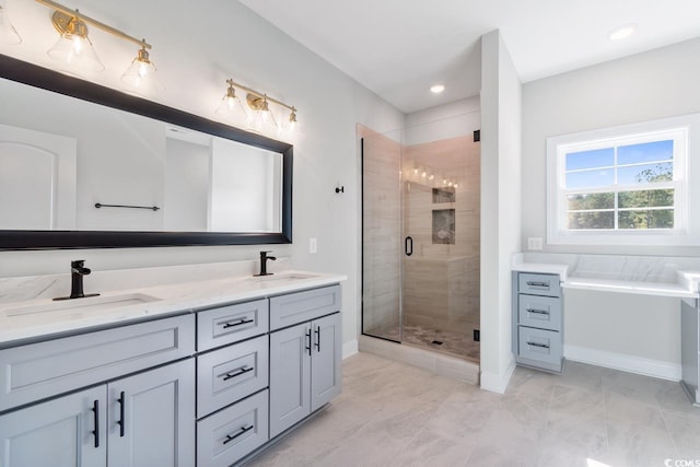 bathroom featuring vanity and independent shower and bath