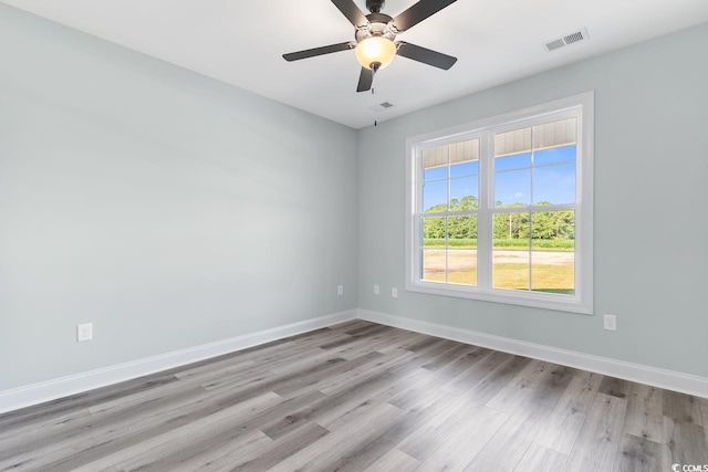 empty room with ceiling fan and light hardwood / wood-style floors