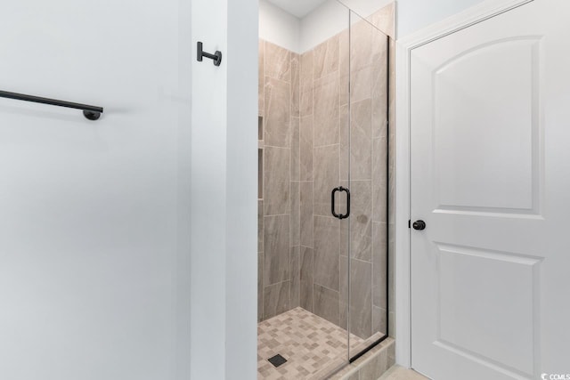 bathroom with a shower with door